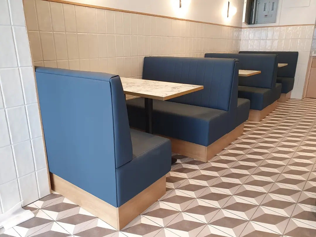 Hospitality interior with upholstered banquette seating and dining furniture